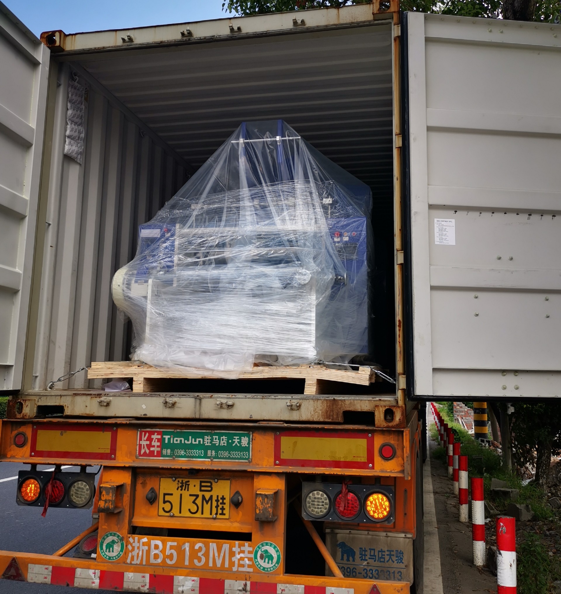 Machines being loaded into containers — ready for shipment.